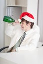 Man celebrates Christmases at office on workplace Royalty Free Stock Photo