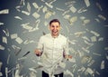 Man celebrates success under money rain falling down dollar bills Royalty Free Stock Photo