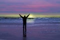 Man celebrates sunrise on a beach