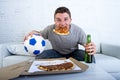 Man celebrating goal at home couch watching football game on television Royalty Free Stock Photo