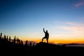 Man celebrating sunset in mountains with arms outstretched Royalty Free Stock Photo