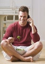 Man With Cell Phone and Salad Royalty Free Stock Photo