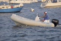 Man on a cellphone while boating in Annaqpolis, Md harbor