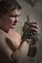 Man with a chain tied hands Royalty Free Stock Photo