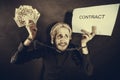 Man with chained hands holding contract and money Royalty Free Stock Photo