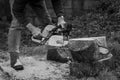 Man Chainsawing Wood in a Garden in Ireland - Black and White Royalty Free Stock Photo