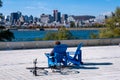 Man in a chair looking at Montreal Skyline from Parc Jean Drapeau, in the Autumn season Royalty Free Stock Photo