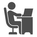 Man in chair at table with laptop solid icon, Coworking concept, freelancer working on laptop sign on white background Royalty Free Stock Photo