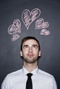 Man and chalk drawn hearts, blackboard wall