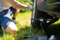 A man changes a wheel after a car breaks down. Transport, travel concept Royalty Free Stock Photo