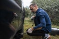 A man changes a wheel after a car breaks down. Transport, travel concept Royalty Free Stock Photo