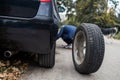 A man changes a wheel after a car breaks down. Transport, travel concept Royalty Free Stock Photo