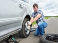 Man changing a spare tire of car Royalty Free Stock Photo