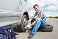 Man changing spare tire of car Royalty Free Stock Photo