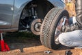 Man is changing summer car wheel, tire before winter