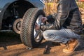 Man is changing summer car wheel, tire before winter