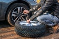 Man is changing summer car wheel, tire before winter