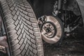 Man is changing summer car wheel, tire before winter