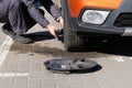 Man is changing wheel after a car break down. Damaged car tyre. Wheel balancing or repair and change car tire. Auto repair concept Royalty Free Stock Photo