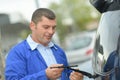 Man changing windscreen wipers on car