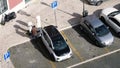 Man charging BMW i3 car in central Lisbon Portugal