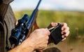 Man is charging a hunting rifle. Male hunter in ready to hunt. Closeup. Ammunition with a gun, cartridges. Hunter man Royalty Free Stock Photo