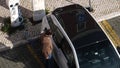 Man charging new BMW German i3 car in Parking