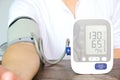 Man check blood pressure monitor and heart rate monitor with digital pressure gauge. Health care and Medical concept Royalty Free Stock Photo