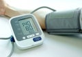 Man check blood pressure monitor and heart rate monitor with digital pressure gauge. Health care and  Medical concept Royalty Free Stock Photo