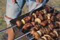 meat kebab is cooked on the grill. checking the readiness of the barbecue. Royalty Free Stock Photo