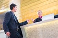 Man on business trip at hotel reception Royalty Free Stock Photo