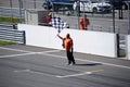 A man with a checkered flag on the race bikes track Royalty Free Stock Photo