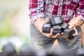 Man in a checkered shirt holding cubes of charcoal briquettes