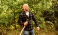Man checkered shirt use axe. brutal and attractive male in forest. power and strength. lumberjack carry ax. bald