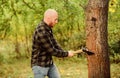 Man checkered shirt use axe. Brutal male in forest. Power and strength. Lumberjack carry ax. Bald woodsman. Harvest