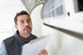 Man checking airconditioning unit