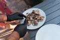 Man checking barbecue chicken with knife. Delicious meat.