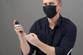Man checking blood sugar level with glucometer on gray background Royalty Free Stock Photo