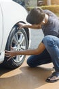 Man checking car tire Royalty Free Stock Photo