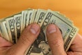 Man checking or counting a handful of banknotes