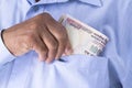 Man checking or counting Indian rupees in hand.