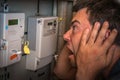 Man is checking electricity meter - expensive electricity concep Royalty Free Stock Photo