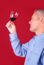 Man checking a glass of red wine