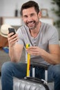 man checking hand luggage size using tape meter Royalty Free Stock Photo