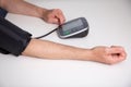 Man checking his blood pressure at home with a digital blood pressure monitor Royalty Free Stock Photo