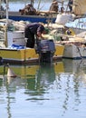 Man checking on his boat in Trani, Italy