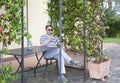 Man checking his mobile phone on a terrace