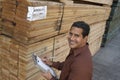 Man Checking Lumber In Warehouse