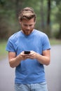 man checking online content walking in park