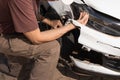 Man checking out the damage to the front end of his car Royalty Free Stock Photo